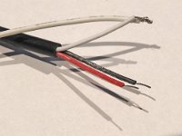 Here the separate ends of the 3-pin cable have been cut and stripped, and twisted over the sensor cable end. Solder is best but it seems fine with just heat-shrink